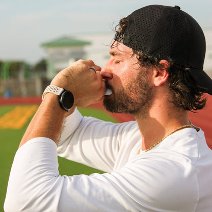 Athlete drinking Salty Syrup endurance gel mid-workout